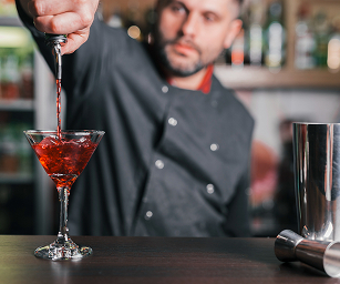 Barman pouring cocktail