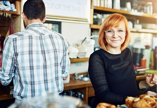 woman smiling at coffee counter